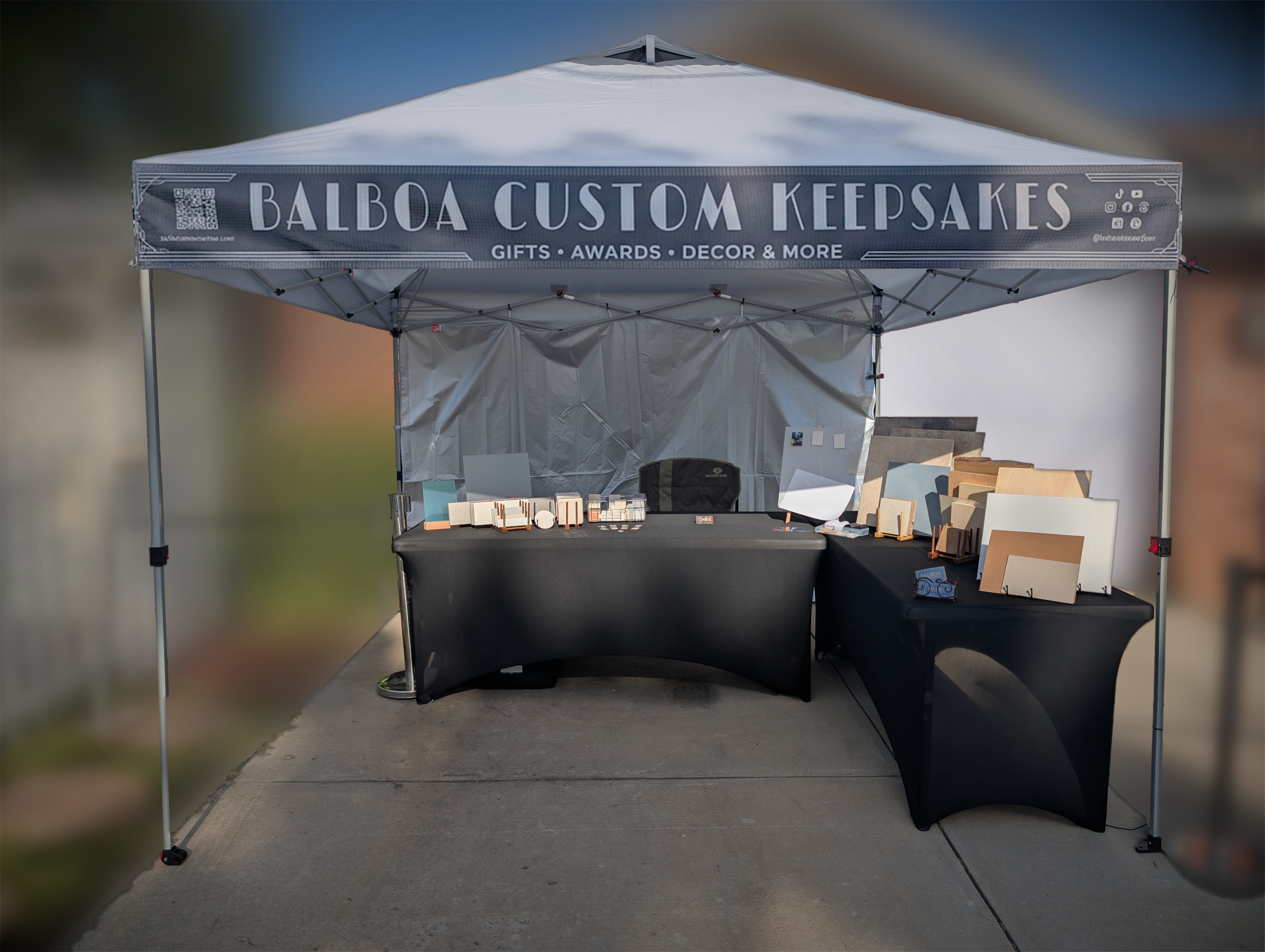 Balboa Custom Keepsakes field studio set up in daylight under a white canopy